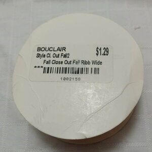 The remaining long length of a roll of vintage ribbon with an floral pattern